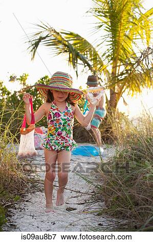 Girl and brother collecting seashells at beach, Sanibel, Florida, USA View Large Photo Image Stock Photo - Girl and brother collecting seashells at beach, Sanibel, Florida, USA. Fotosearch