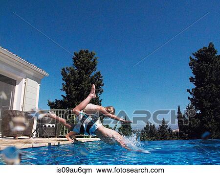 Girl and teenage brother diving into apartment swimming pool View Large Photo Image Picture - Girl and teenage brother diving into apartment swimming pool. Fotosearch