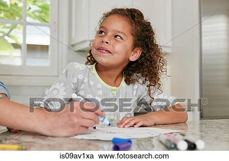 Girl at kitchen counter using felt tip pen to draw picture, looking up smiling View Large Photo Image Stock Image - Girl at kitchen counter using felt tip pen to draw picture, looking up smiling. Fotosearch