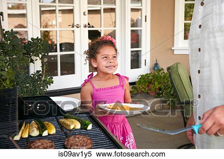 Girl on patio holding plate being served barbeque food by father View Large Photo Image Stock Photography - Girl on patio holding plate being served barbeque food by father. Fotosearch