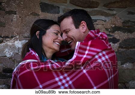 Happy romantic mature couple wrapped in blanket at night View Large Photo Image Stock Image - Happy romantic mature couple wrapped in blanket at night. Fotosearch