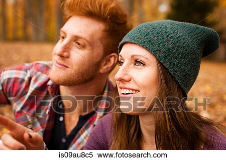 Stock Photography - Happy young couple in autumn forest. Fotosearch
