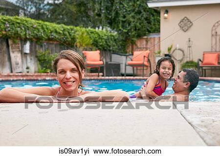 Head and shoulders of mid adult woman with family in pool looking at camera smiling View Large Photo Image Stock Image - Head and shoulders of mid adult woman with family in pool looking at camera smiling. Fotosearch
