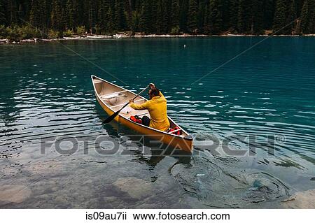 High angle rear view of mid adult man paddling canoe on Moraine lake, Banff National Park, Alberta Canada View Large Photo Image Stock Image - High angle rear view of mid adult man paddling canoe on Moraine lake, Banff National Park, Alberta Canada. Fotosearch