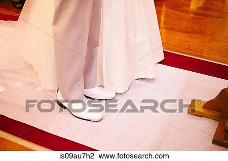 High angle view of feet of bride and bridegroom standing together in church View Large Photo Image Stock Image - High angle view of feet of bride and bridegroom standing together in church. Fotosearch