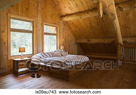 King Size Bed With Wooden Bed Frame In The Master Bedroom On