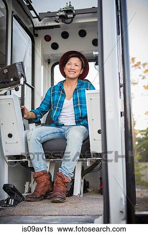 Mature female crane operator operating crane on building site View Large Photo Image Stock Photograph - Mature female crane operator operating crane on building site. Fotosearch