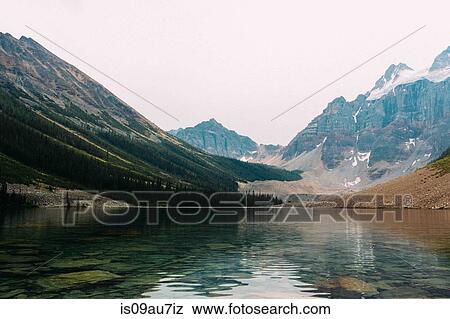 Moraine Lake beneath snow capped mountain range, Banff National Park, Alberta Canada View Large Photo Image Stock Photo - Moraine Lake beneath snow capped mountain range, Banff National Park, Alberta Canada. Fotosearch