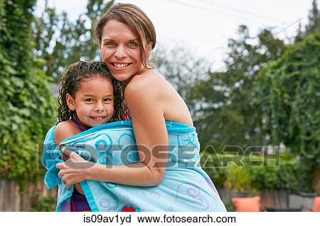 Mother and daughter wearing swimwear wrapped in towel looking at camera smiling View Large Photo Image Stock Image - Mother and daughter wearing swimwear wrapped in towel looking at camera smiling. Fotosearch