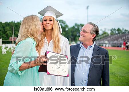 Mother kissing graduate daughter at graduation ceremony View Large Photo Image Stock Photograph - Mother kissing graduate daughter at graduation ceremony. Fotosearch