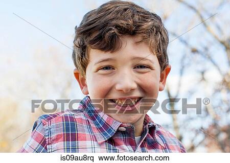 Portrait of boy wearing checked shirt looking at camera smiling View Large Photo Image Stock Photography - Portrait of boy wearing checked shirt looking at camera smiling. Fotosearch