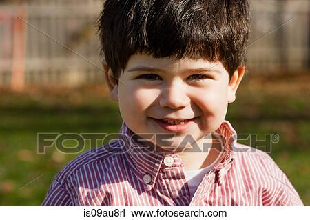 Portrait of dark haired boy wearing striped shirt looking at camera smiling View Large Photo Image Stock Image - Portrait of dark haired boy wearing striped shirt looking at camera smiling. Fotosearch