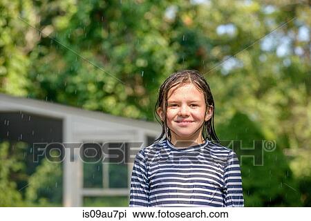 Portrait of girl in garden, wet hair, smiling View Large Photo Image Stock Image - Portrait of girl in garden, wet hair, smiling. Fotosearch
