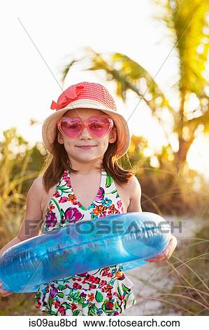 Portrait of girl wearing sunglasses and sunhat at beach, Sanibel, Florida, USA View Large Photo Image Stock Image - Portrait of girl wearing sunglasses and sunhat at beach, Sanibel, Florida, USA. Fotosearch