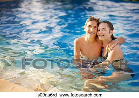 Portrait of teenage boy and girl in outdoor swimming pool View Large Photo Image Stock Image - Portrait of teenage boy and girl in outdoor swimming pool. Fotosearch
