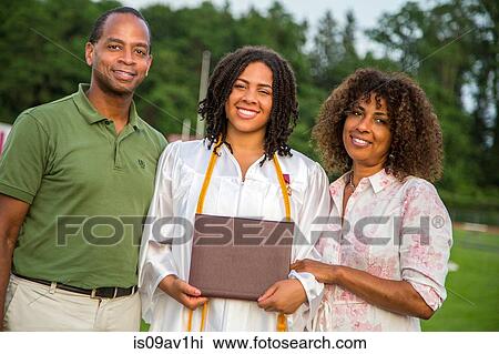 Portrait of teenage girl with parents at graduation ceremony View Large Photo Image Stock Image - Portrait of teenage girl with parents at graduation ceremony. Fotosearch