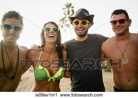 Portrait of young woman and three young men on beach, Newport Beach, California, USA View Large Photo Image Stock Image - Portrait of young woman and three young men on beach, Newport Beach, California, USA. Fotosearch