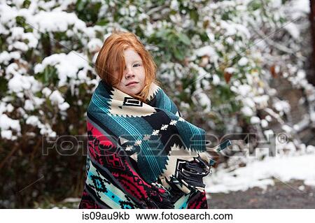 Red haired girl in front of snow covered trees, wrapped in aztec pattern blanket looking at camera View Large Photo Image Stock Image - Red haired girl in front of snow covered trees, wrapped in aztec pattern blanket looking at camera. Fotosearch