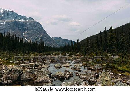 Rocky riverbed and mountain range, Moraine lake, Banff National Park, Alberta Canada View Large Photo Image Stock Photo - Rocky riverbed and mountain range, Moraine lake, Banff National Park, Alberta Canada. Fotosearch