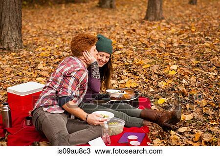 Romantic young couple having picnic in autumn forest View Large Photo Image Stock Image - Romantic young couple having picnic in autumn forest. Fotosearch