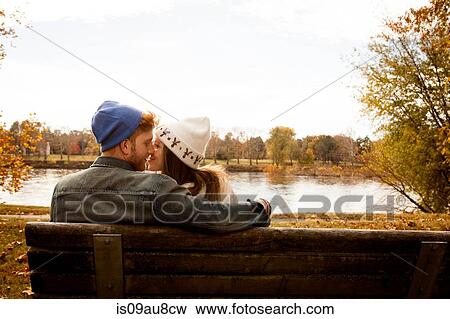 Romantic young couple on park bench at lakeside View Large Photo Image Stock Photo - Romantic young couple on park bench at lakeside. Fotosearch