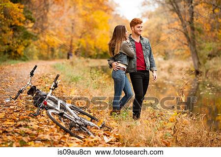 Romantic young couple on riverside in autumn View Large Photo Image Picture - Romantic young couple on riverside in autumn. Fotosearch
