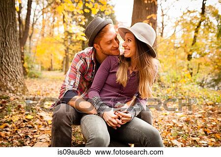 Romantic young couple sitting in autumn forest View Large Photo Image Stock Image - Romantic young couple sitting in autumn forest. Fotosearch