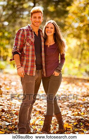 Sunlit portrait of young couple in autumn forest View Large Photo Image Picture - Sunlit portrait of young couple in autumn forest. Fotosearch