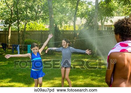 Three children playing garden with garden hose View Large Photo Image Stock Image - Three children playing garden with garden hose. Fotosearch