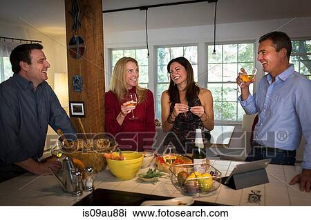 Two mature couples drinking wine at dinner party View Large Photo Image Stock Image - Two mature couples drinking wine at dinner party. Fotosearch