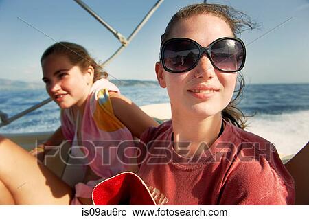 Two teenage girls on boat at sea View Large Photo Image Stock Image - Two teenage girls on boat at sea. Fotosearch