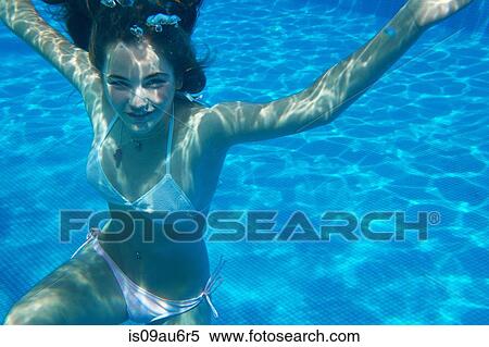 Underwater portrait of girl in swimming pool View Large Photo Image Stock Photography - Underwater portrait of girl in swimming pool. Fotosearch