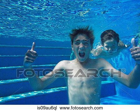 Underwater view of boy giving thumbs up in swimming pool View Large Photo Image Stock Image - Underwater view of boy giving thumbs up in swimming pool. Fotosearch