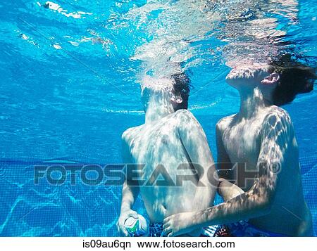 Underwater view of two boys playing ball game in swimming pool View Large Photo Image Picture - Underwater view of two boys playing ball game in swimming pool. Fotosearch