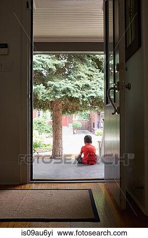 Young boy sitting on front step of house, rear view View Large Photo Image Stock Image - Young boy sitting on front step of house, rear view. Fotosearch