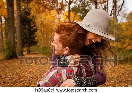 Young couple hugging in autumn forest View Large Photo Image Stock Image - Young couple hugging in autumn forest. Fotosearch