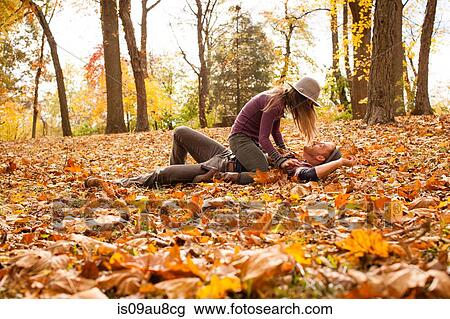 Young couple play fighting on autumn forest floor View Large Photo Image Stock Image - Young couple play fighting on autumn forest floor. Fotosearch