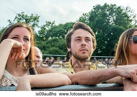 Young man and sisters watching graduation ceremony View Large Photo Image Stock Photograph - Young man and sisters watching graduation ceremony. Fotosearch