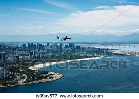 Airplane flying over coastline, Zona Central, Rio de Janeiro, Brazil View Large Photo Image Stock Photo - Airplane flying over coastline, Zona Central, Rio de Janeiro, Brazil. Fotosearch