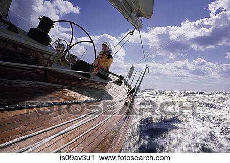 Angled view of mature man sailing yacht on choppy water View Large Photo Image Stock Image - Angled view of mature man sailing yacht on choppy water. Fotosearch