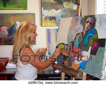 Stock Image - Artist painting artwork on canvas. Fotosearch