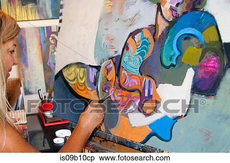 Artist painting artwork on canvas View Large Photo Image Stock Photography - Artist painting artwork on canvas. Fotosearch