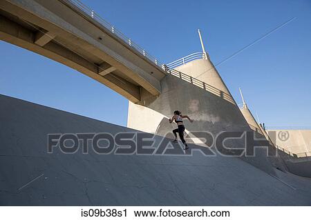 Stock Image - Athlete jogging, Van Nuys, California, USA. Fotosearch