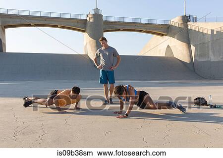 Picture - Athlete observing friends workout, Van Nuys, California, USA. Fotosearch