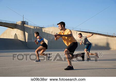 Athletes exercising in unison, Van Nuys, California, USA View Large Photo Image Stock Photography - Athletes exercising in unison, Van Nuys, California, USA. Fotosearch