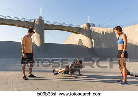Athletes observing friend workout, Van Nuys, California, USA View Large Photo Image Stock Image - Athletes observing friend workout, Van Nuys, California, USA. Fotosearch