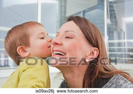 Baby boy kissing mother's cheek View Large Photo Image Stock Image - Baby boy kissing mother's cheek. Fotosearch