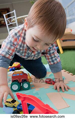 Baby boy playing with toys at home View Large Photo Image Stock Image - Baby boy playing with toys at home. Fotosearch