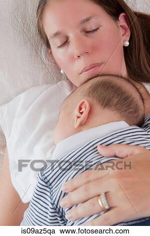Baby boy sleeping on mothers chest View Large Photo Image Stock Image - Baby boy sleeping on mothers chest. Fotosearch