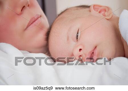 Baby boy sleeping on mothers chest View Large Photo Image Stock Photo - Baby boy sleeping on mothers chest. Fotosearch
